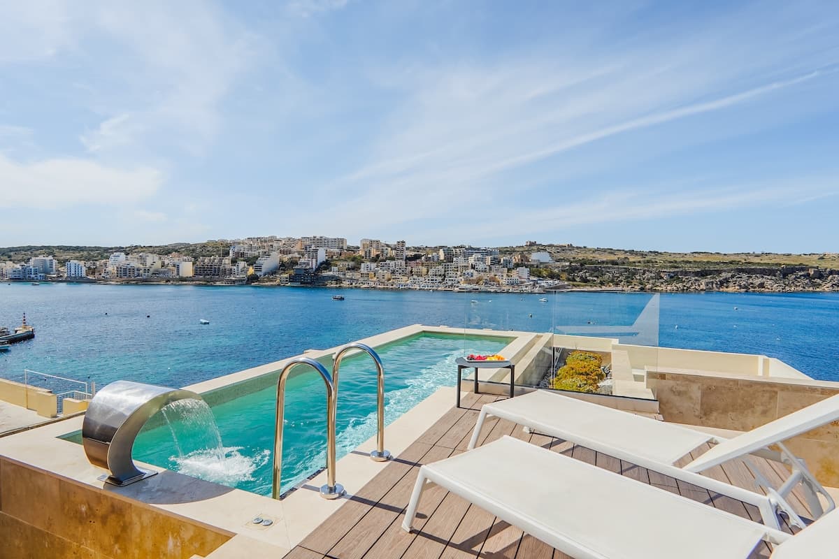 Luxury hotel pool Malta — search: luxury hotel pool Malta blue water sun loungers