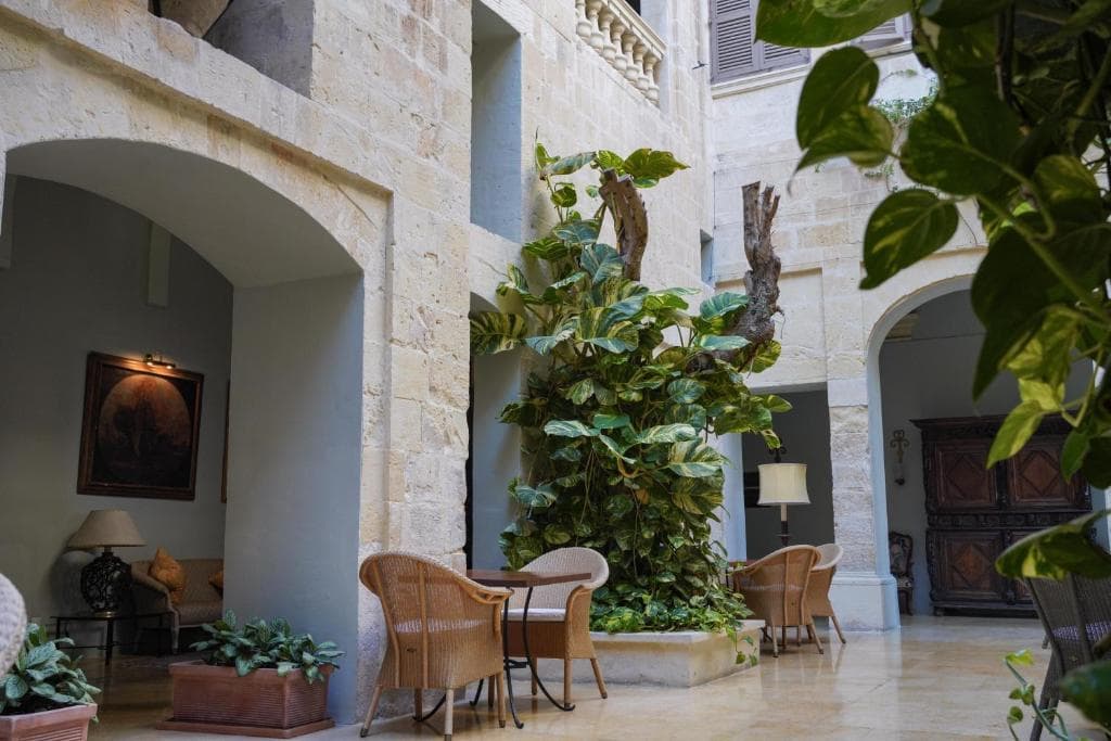 Hotel gardens with Mediterranean plants stone pathways Malta — search: luxury hotel gardens Mediterranean plants stone pathways Malta