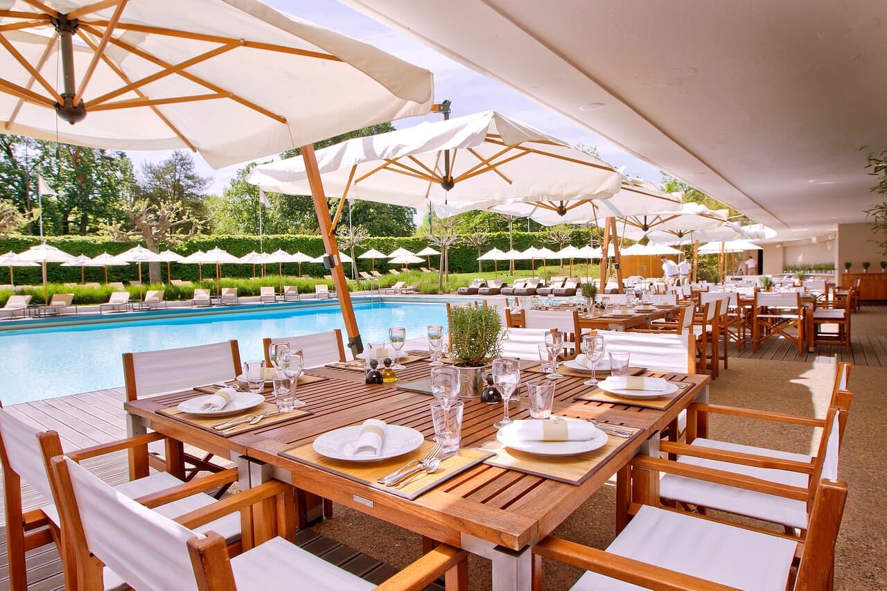 Poolside restaurant luxury hotel with sea view blue water light food — search: poolside restaurant luxury hotel sea view blue water light lunch