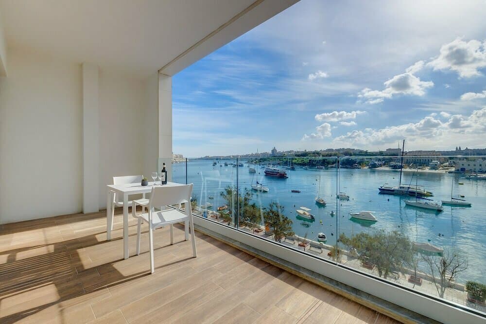Grand harbour suite with panoramic windows overlooking Grand Harbour Valletta Malta — search: grand harbour view suite luxury hotel Valletta Malta panoramic windows