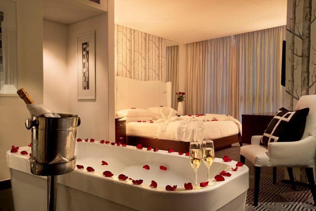 Couple spa retreat luxury hotel room with rose petals champagne — search: couple spa retreat luxury hotel room rose petals champagne romance