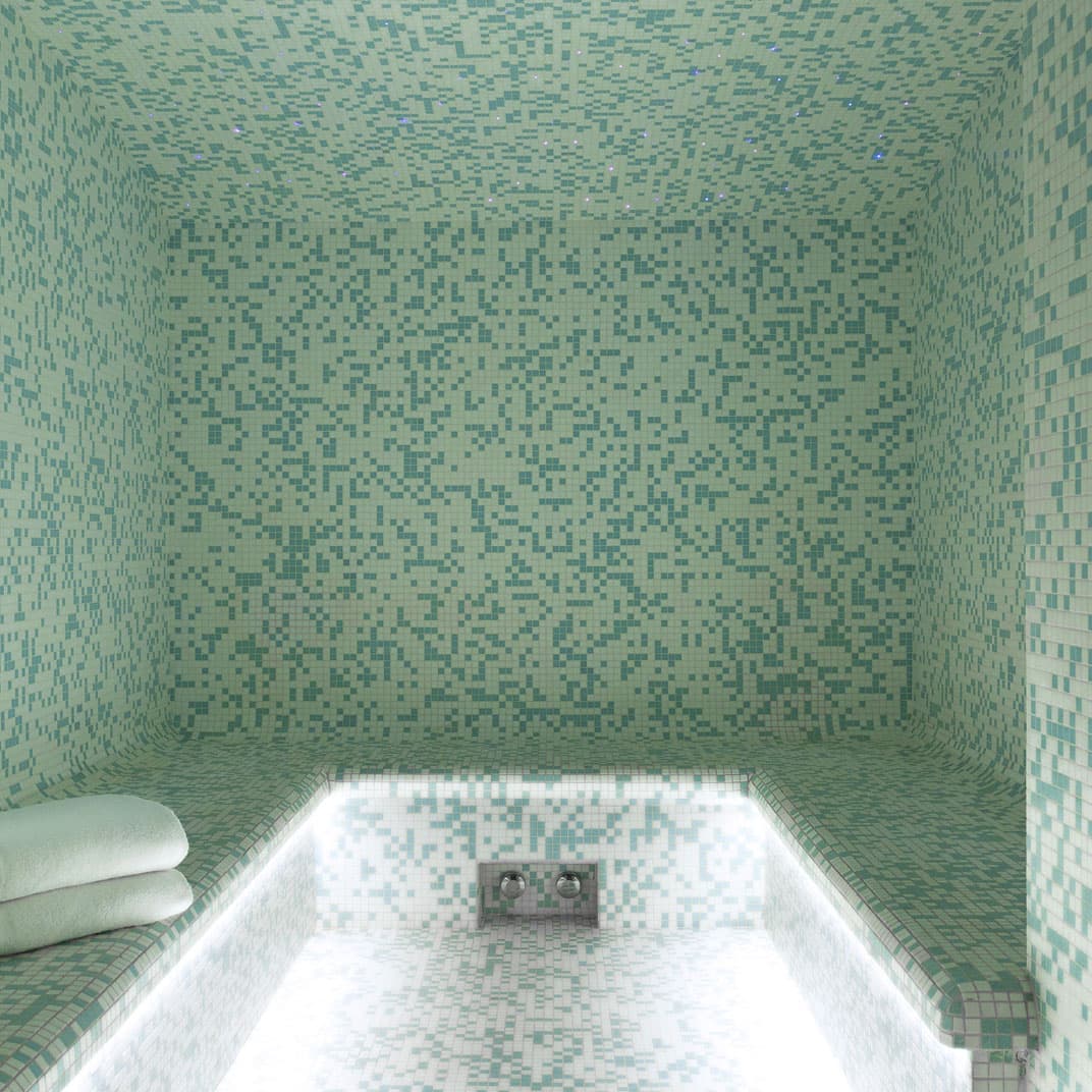 Hammam steam room with mosaic tiles luxury hotel spa — search: luxury hotel spa hammam steam room mosaic tiles arched