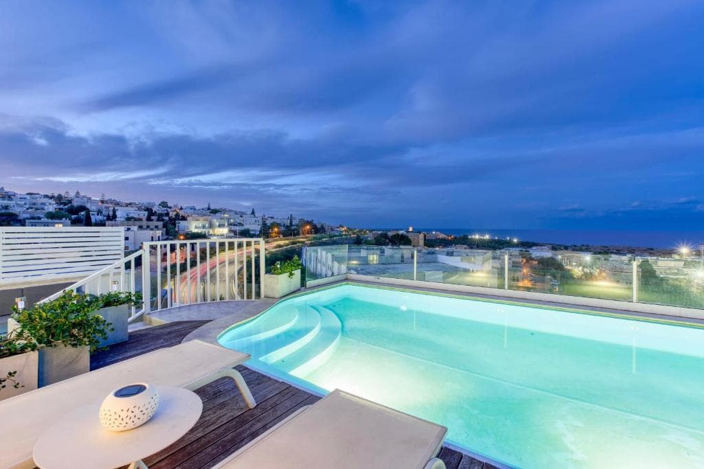 Infinity pool overlooking Mediterranean sea Malta luxury hotel — search: infinity pool overlooking Mediterranean sea Malta luxury hotel sunset